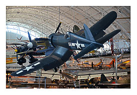 Steven F. Udvar Vague Center Vought F4U 1D Corsair, with P 40 Warhawk in background