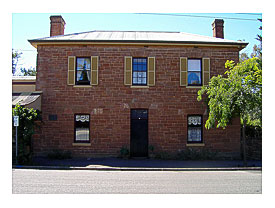 Patrimony listed Georgian style box shaped house in main street of Nairne. 12 paned windows, shutters, unalloyed proportions and symmetry. Built for Henry Timmins a tanner. 3 paned fan light above doorway. Perhaps built in 1851 when Timmins opened his
