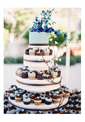 Brown And Blue Wedding Cupcakes With One Tier Cake On The Top By The