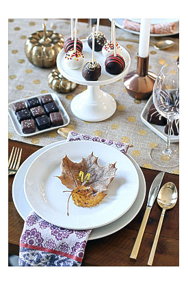 gold leaf initial setting setting with sea salt caramels cake pops from Shari's Berries candle holder decorative pumpkin and silverware