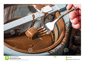 Candy Maker Using A Chocolate Coating Machine To Make Candy