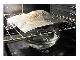 . The Dough Was Placed On A Rack Over A Large Bowl Of Hot Water