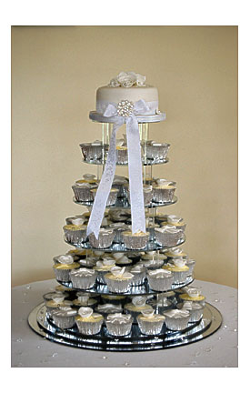 Cake On Top And The Tiered Cupcakes In Silver Wrappers. Each Cupcake