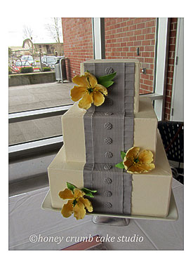 Depressing Box Pleated Wedding Cake with Yellow Sugar Blooms